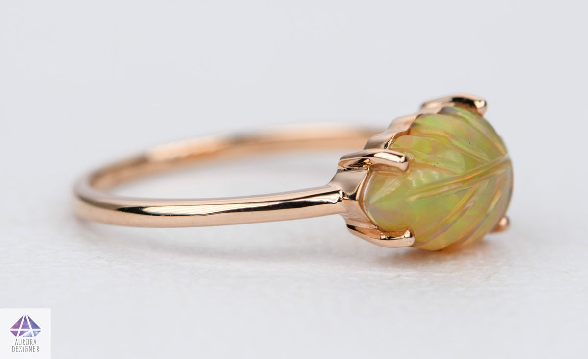 https://www.auroradesigner.com/cdn/shop/products/ethiopian-opal-carving-14k-rose-gold-ring-unique-ooak-carved-gemstone-leaf-nature-inspired-ad2006-2-aurora-designer-883073_1200x.jpg?v=1689357857